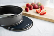 Reusable cake tin liners with strawberries in the background