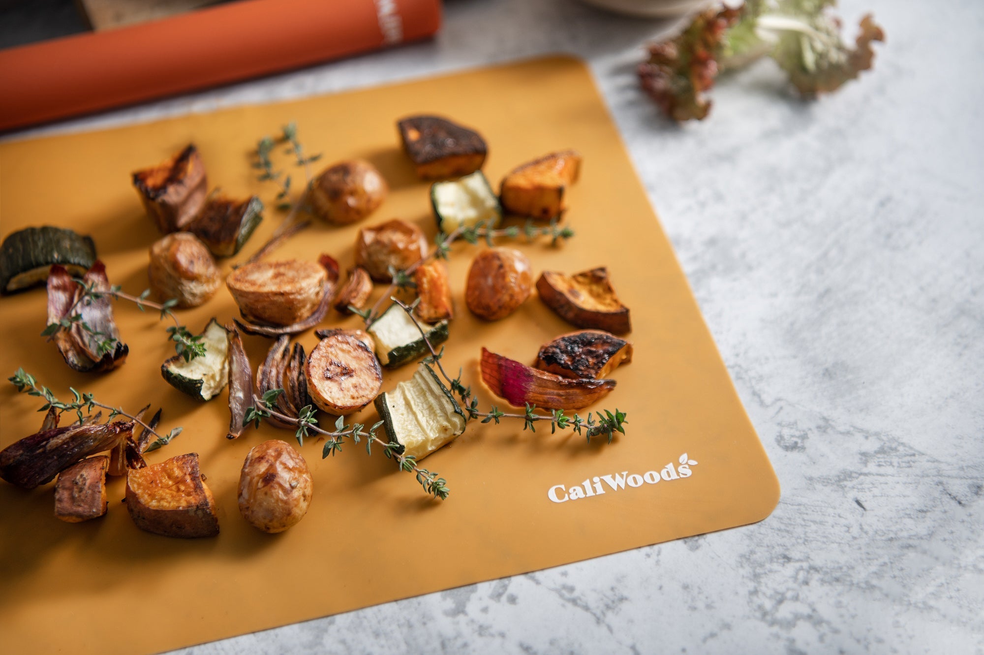 Roast vegetables on the orange Reusable Baking Mat 