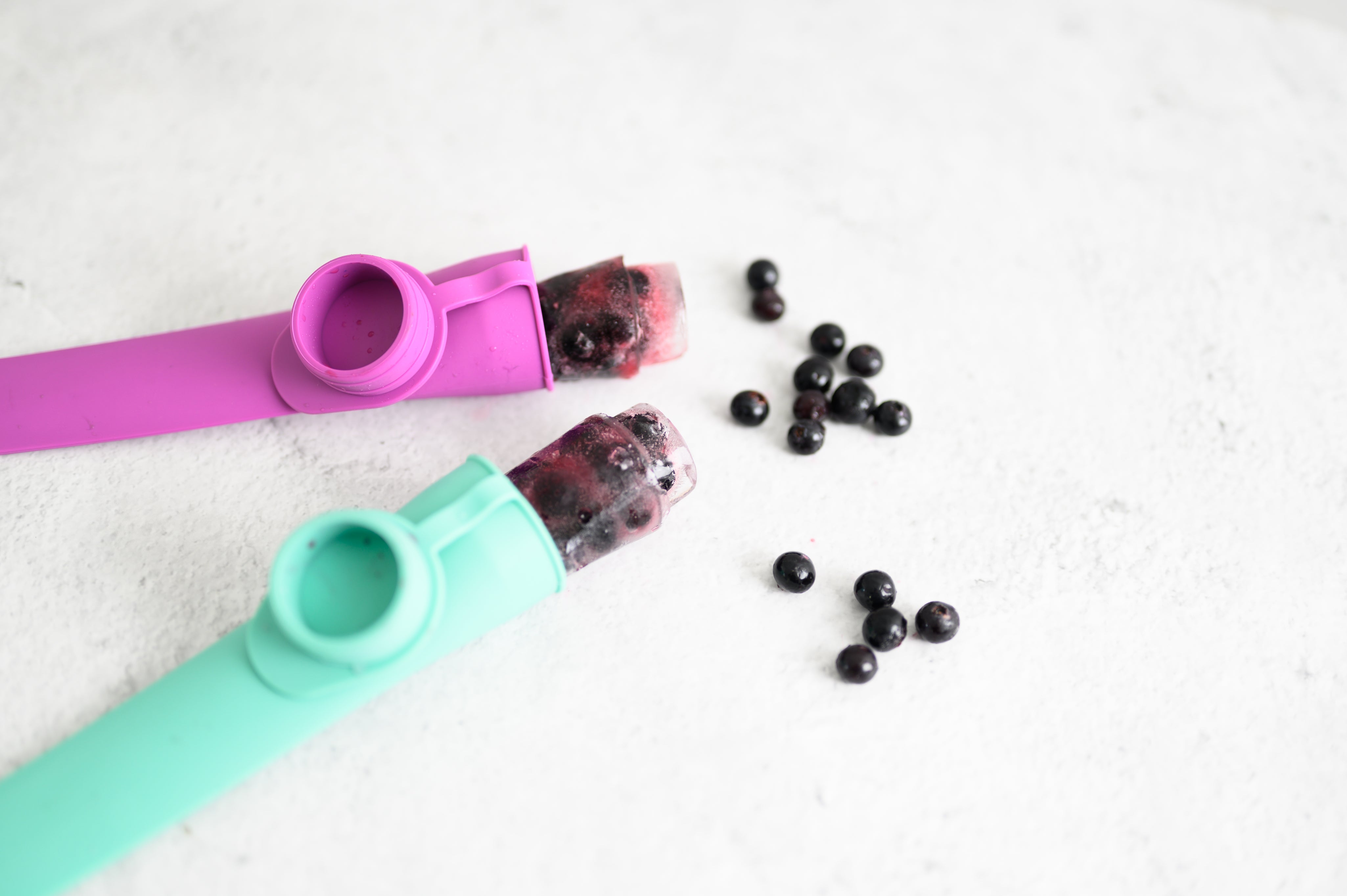 teal and purple reuseable ice block moulds with iced berry block and blueberries from CaliWoods